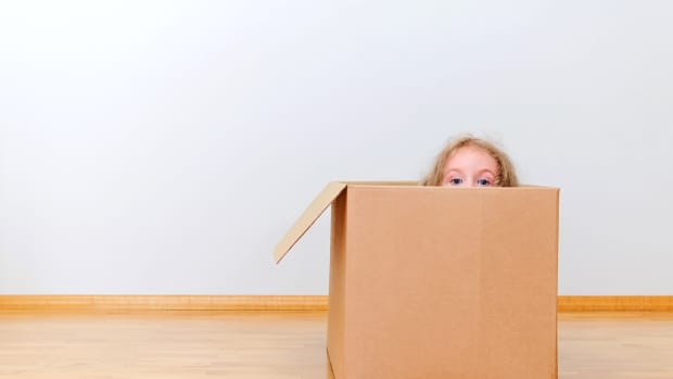 little kid in cardboard box